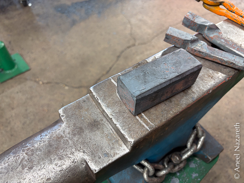 A block of tool steel sitting on an anvil